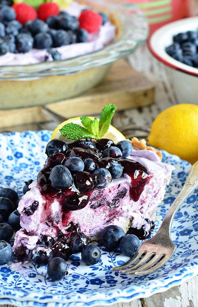 Blueberry Yogurt Pie is the perfect dessert for summer, serve frozen or cold from the refrigerator. With a shortbread crust filled with lemon zest filled with greek yogurt and blueberries this yogurt pie is sure to go fast!