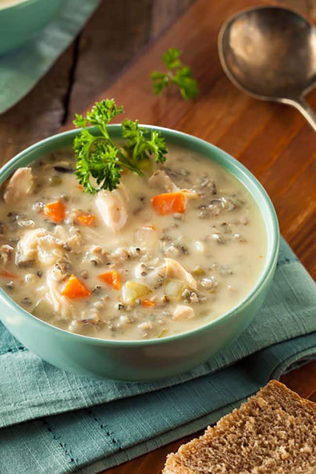 homemade wild rice and chicken soup in a blue bowl