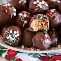 peanut butter balls with Christmas sprinkles on a plate