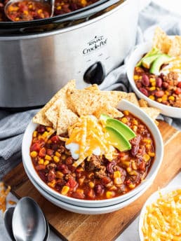 taco soup on a bowl in front of a slow cooker