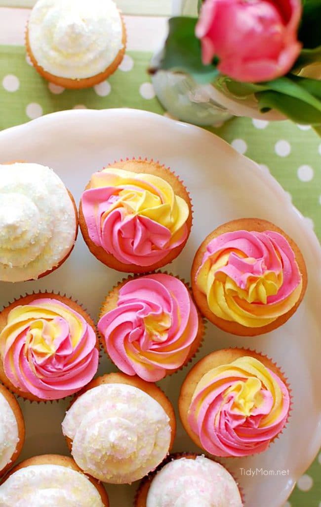 raspberry filled cupcakes with pink and yellow vanilla buttrcream