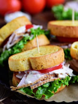 Turkey Caesar Sandwich. Easy homemade caesar dressing and garlic toast turns an ordinary cold-cut sandwich into something special. Perfect way to use up left-over Thanksgiving turkey or any day with deli sliced turkey! Print recipe at TidyMom.net