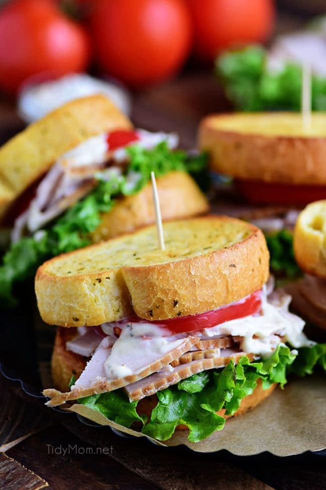 Turkey Caesar Sandwich. Easy homemade caesar dressing and garlic toast turns an ordinary cold-cut sandwich into something special. Perfect way to use up left-over Thanksgiving turkey or any day with deli sliced turkey! Print recipe at TidyMom.net