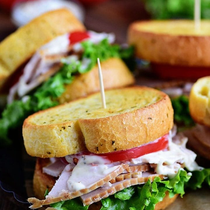 Turkey Caesar Sandwich. Easy homemade caesar dressing and garlic toast turns an ordinary cold-cut sandwich into something special. Perfect way to use up left-over Thanksgiving turkey or any day with deli sliced turkey! Print recipe at TidyMom.net