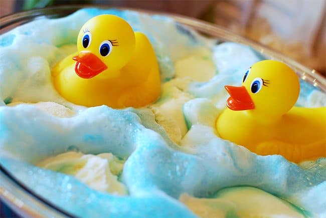 This Adorable Ducky Baby Shower Punch made with blue Kool-Aid gives the look of bath water and bubbles made of sherbet mixed with the ginger ale for the perfect party refreshment. Get this party punch recipe at TidyMom.net #punch #babyshower #birthday #ducks