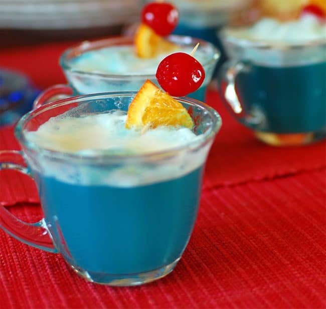 This Adorable Ducky Baby Shower Punch made with blue Kool-Aid gives the look of bath water and bubbles made of sherbet mixed with the ginger ale for the perfect party refreshment. Get this party punch recipe at TidyMom.net #punch #babyshower #birthday #ducks