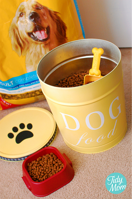 Make your own customized DIY dog food tin storage canister for just a few dollars from an empty popcorn tin. Knock-off Ballard Dog Food Tin directions at TidyMom.net