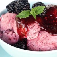 Blackberry no-churn ice cream in a bowl with mint garnish