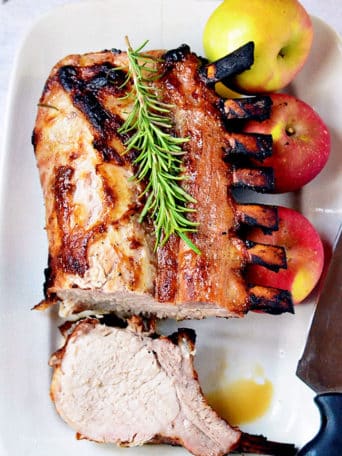 juicy brined rack of pork on white platter