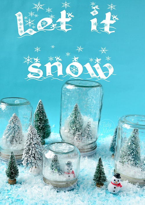 homemade waterless snow globes on a blue background with faux snow