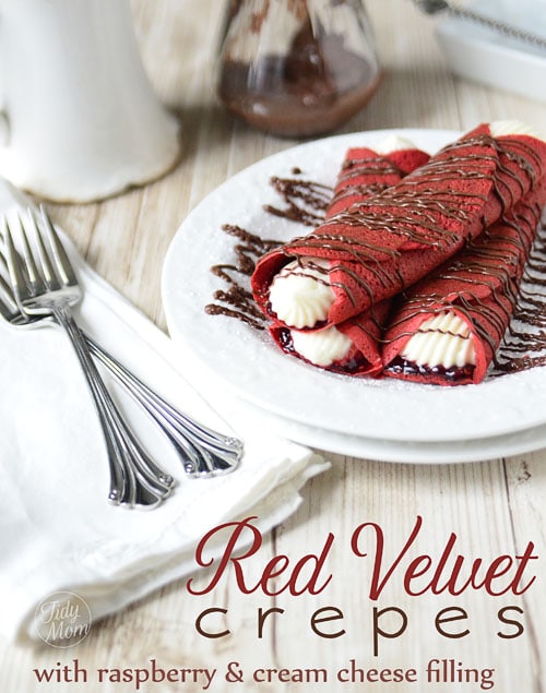 These Red Velvet Crepes will satisfy a multitude of cravings with raspberry preserves and a kicked up sweet cream cheese filling to the Nutella drizzled over top! A perfect treat for Valentines Day or any day! Print the full recipe at TidyMom.net