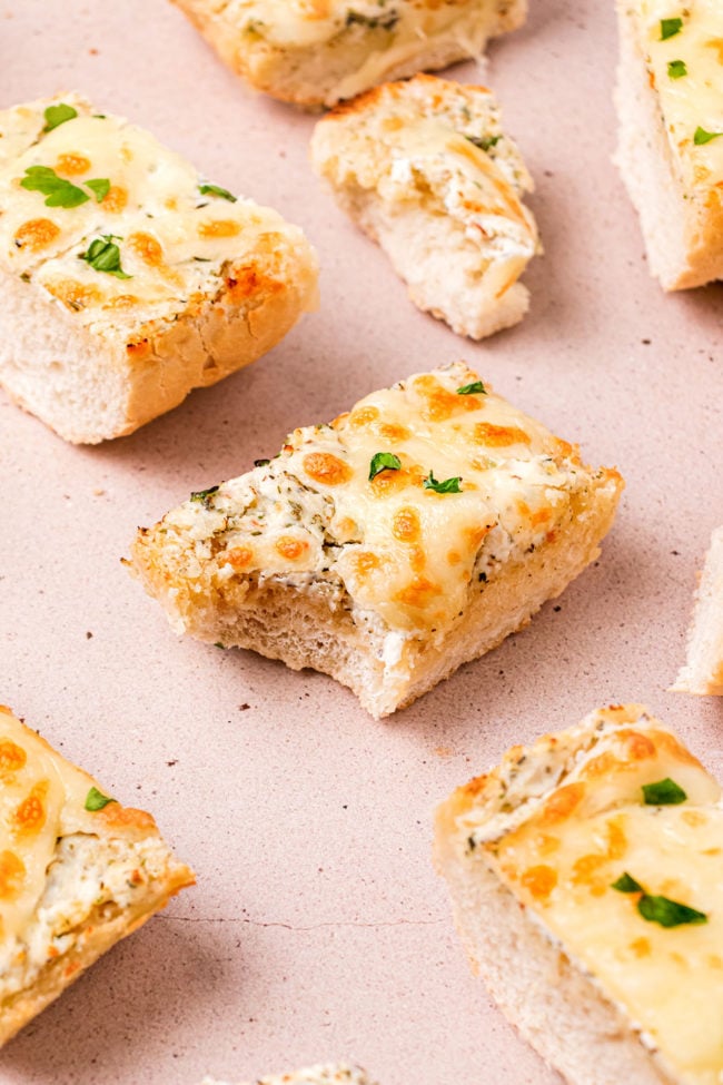 Piece of Garlic Cheese Bread with bite taken