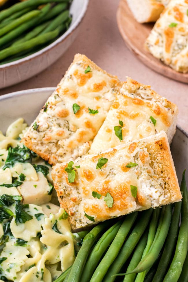 Garlic Cheese Bread plated with pasta and green beans
