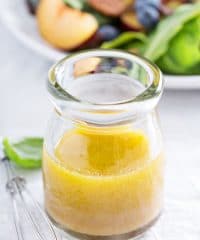 Honey Vinaigrette Dressing in a jar with a salad