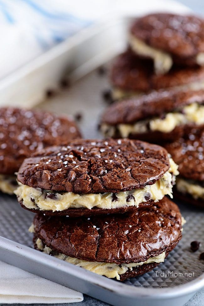 Sandwich Brownie Cookies with Cookie Dough Frosting will be your new favorite treat! A chewy decadent brownie sandwich cookie filled with chocolate chip cookie dough frosting that gives the whole ensemble a five-star rating from any brownie lover. Print the full recipe at TidyMom.net #brownies #cookies #chocolate #cookiedough #chocolatechip
