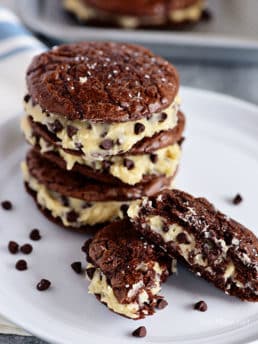 Sandwich Brownie Cookies with Cookie Dough Frosting will be your new favorite treat! A chewy decadent brownie sandwich cookie filled with chocolate chip cookie dough frosting that gives the whole ensemble a five-star rating from any brownie lover. Print the full recipe at TidyMom.net #brownies #cookies #chocolate #cookiedough #chocolatechip