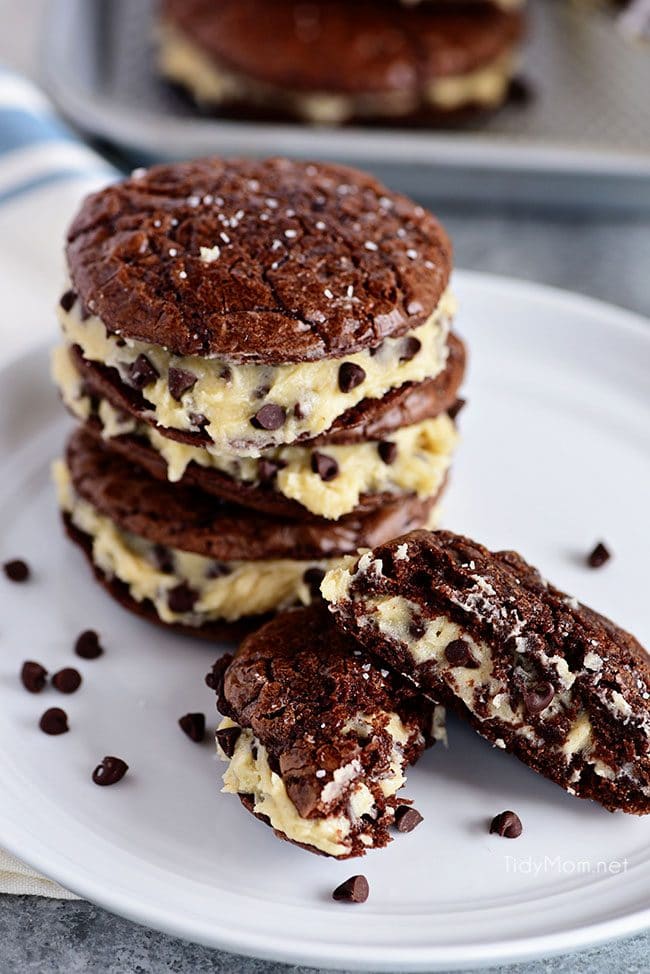 Sandwich Brownie Cookies with Cookie Dough Frosting will be your new favorite treat! A chewy decadent brownie sandwich cookie filled with chocolate chip cookie dough frosting that gives the whole ensemble a five-star rating from any brownie lover. Print the full recipe at TidyMom.net #brownies #cookies #chocolate #cookiedough #chocolatechip