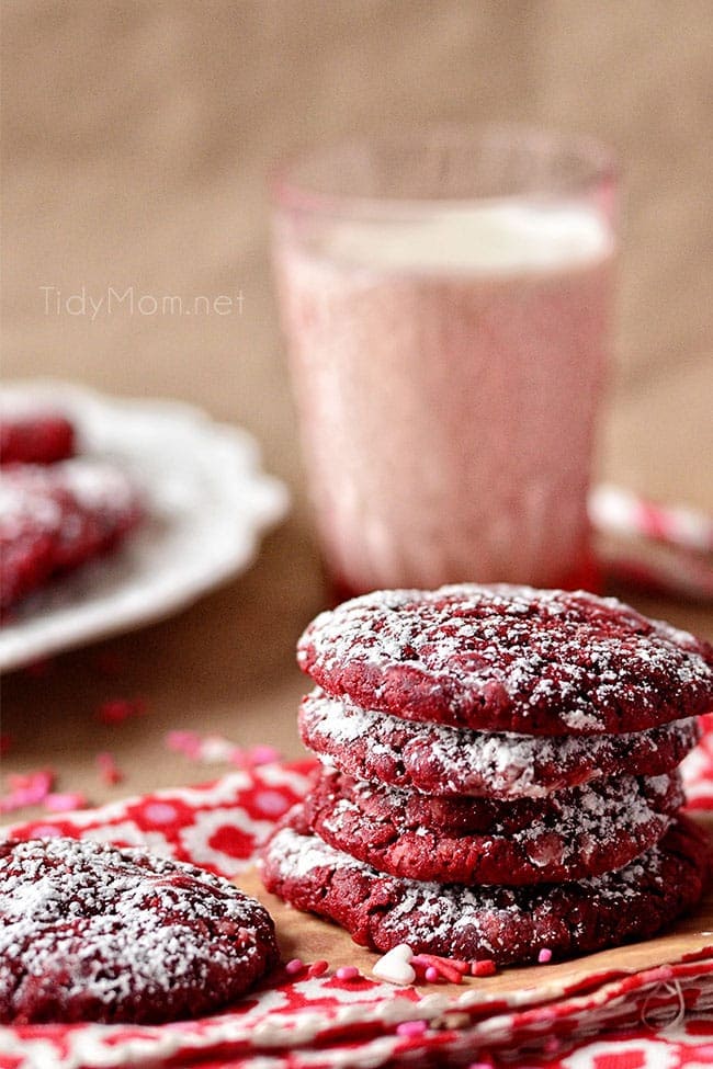 stack of red velvet cookies with a glass of milk