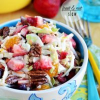 slaw with fruit and nuts in a blue bowl