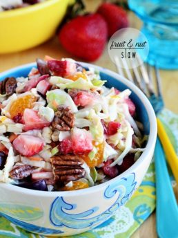 slaw with fruit and nuts in a blue bowl