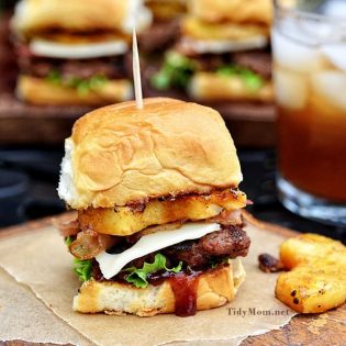 Fire up the grill this summer for this mini Hawaiian burger recipe. Aloha BBQ Sliders are flavored with barbecue sauce and served on sweet rolls with cheese, pineapple and bacon.