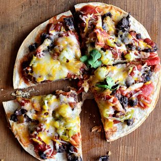 mexican pizza with black beans cut into four slices