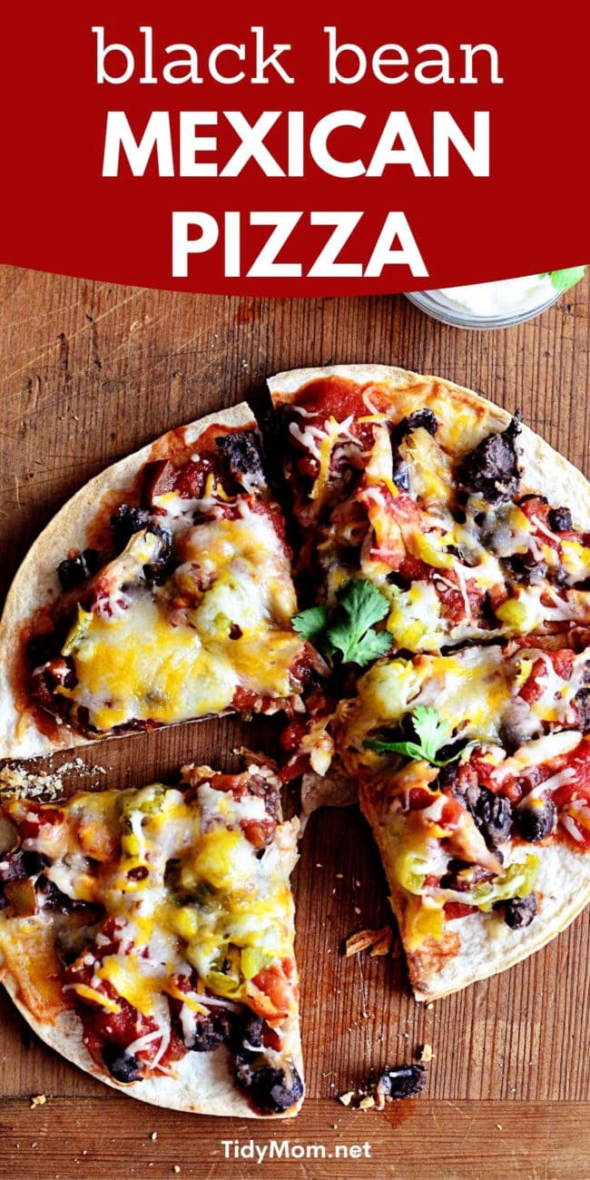 mexican pizza cut into four pieces on a cutting board