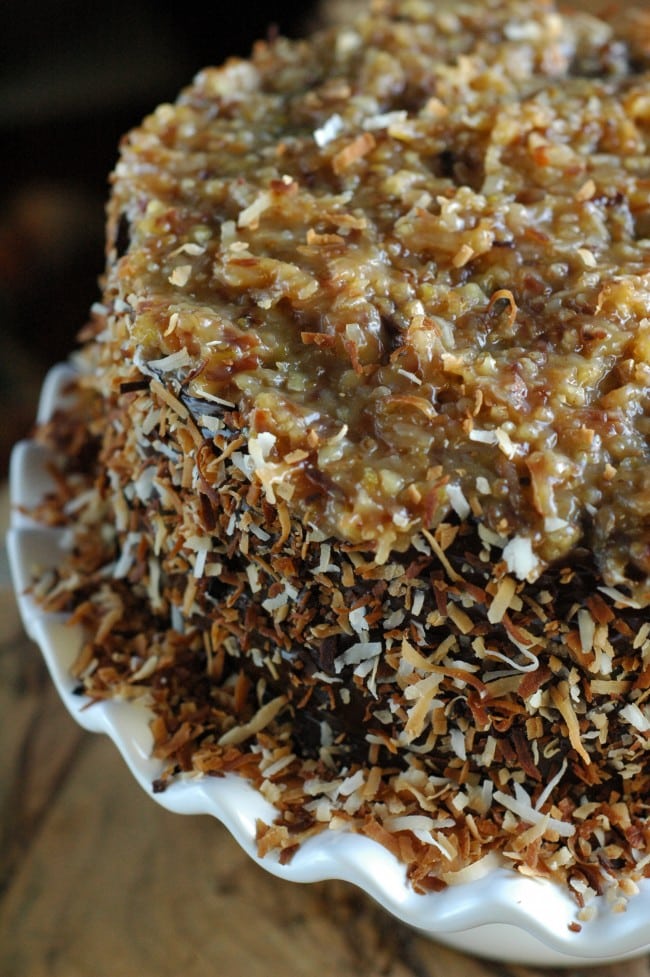 German Chocolate Cake infused with rum and toasted coconut! Jaw dropping Toasted Coconut German Chocolate Cake recipe at TidyMom.net