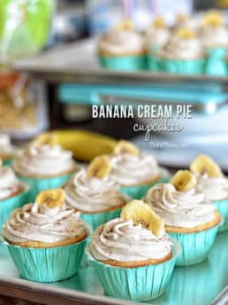 Light, tender vanilla cupcake filled with a luscious banana cream custard and topped with a banana buttercream.....reminiscent of banana cream pie. Print the full recipe for Banana Cream Pie Cupcakes at TidyMom.net