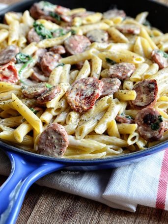 TSavory smoked turkey sausage combined with sun-dried tomatoes, garlic, spinach, and Parmesan cheese make this a sensational 15-minute Smoked Sausage Alfredo recipe the whole family will love. Get the full printable recipe at TidyMom.net