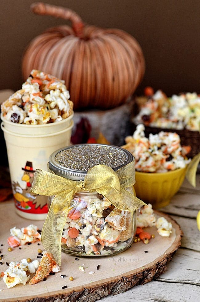 Turkey Munch - Fall Popcorn Snack Mix with bugles, Reeses pieces and sprinkles all drizzled in white chocolate and pumpkin candy melts. Perfect for gifting or at childrens table on Thanksgiving Recipe at Tidymom.net