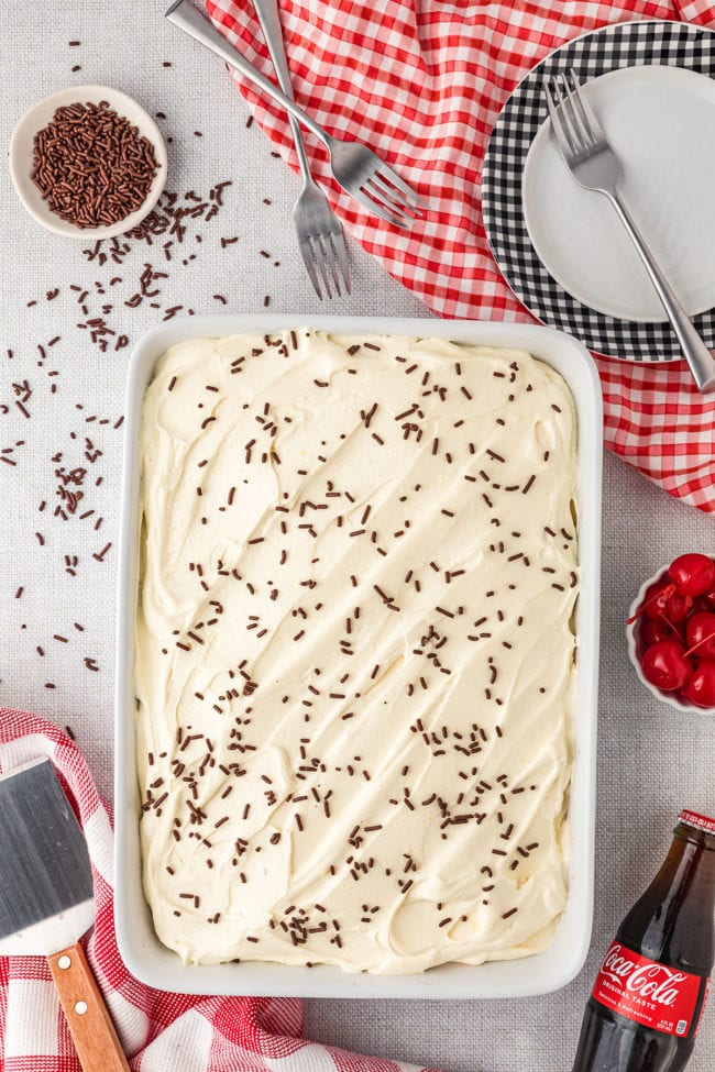 cake with white frosting and chocolate jimmies on top