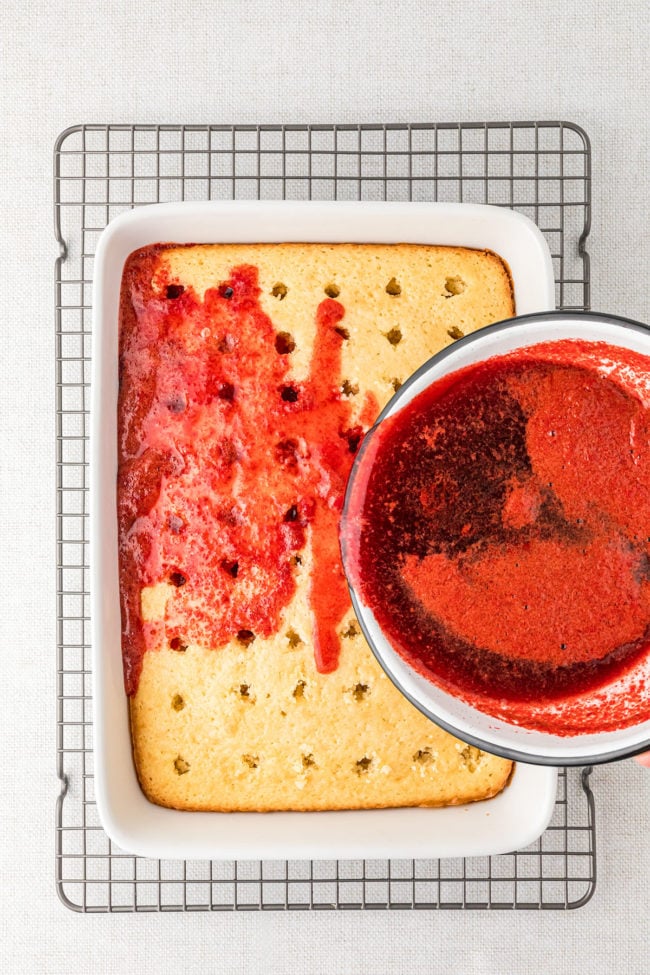 pouring jello over cake with holes