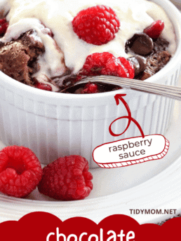 chocolate bread pudding in a white dish with fresh raspberries