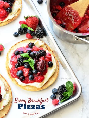 Mixed Berry Breakfast pizza tastes as good as it looks! It's impossible to resist the toasted pita crust, rich orange cream cheese layer and glossy berry topping. It's so convenient to prepare the night before and serve the next morning, or any time of day! Full recipe at TidyMom.net