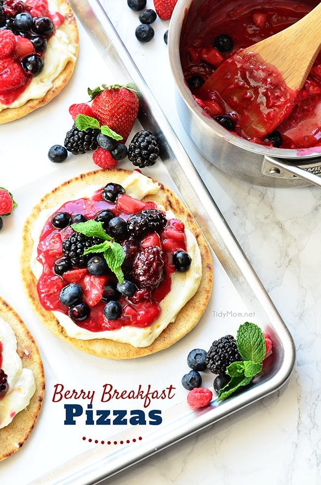 Mixed Berry Breakfast pizza tastes as good as it looks! It's impossible to resist the toasted pita crust, rich orange cream cheese layer and glossy berry topping. It's so convenient to prepare the night before and serve the next morning, or any time of day! Full recipe at TidyMom.net