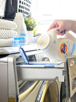 pouring liquid laundry detergent into washing machine