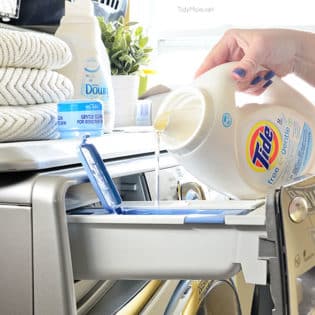 pouring liquid laundry detergent into washing machine
