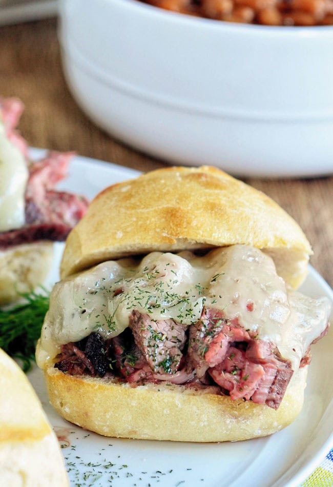 steak sandwich with cheese and dill butter on toasted bun