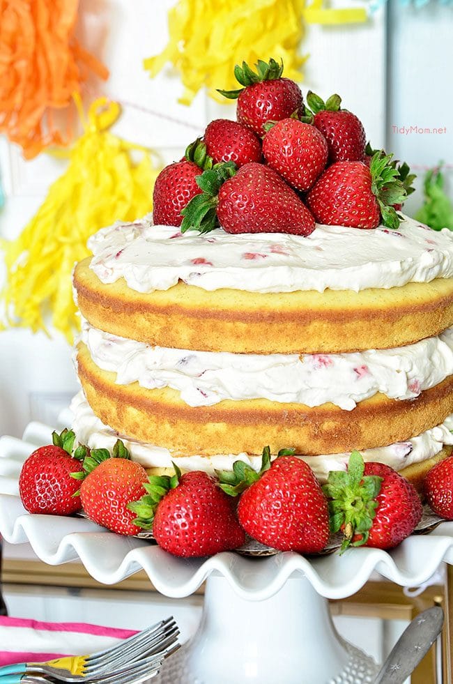 Homemade Strawberries and Cream Naked Cake recipe: 3 delicious layers of homemade pound cake, with fresh strawberries and a dreamy vanilla whipped cream cream cheese frosting at TidyMom.net