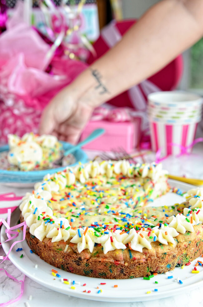 cookie cake with lots of sprinkles on a party table