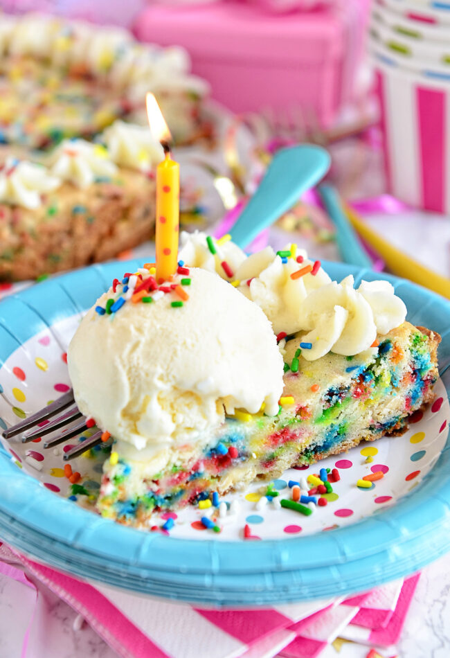 slice of cookie cake with ice cream and a candle