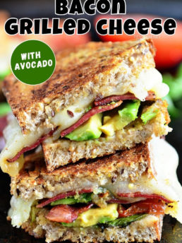 grilled cheese sandwich with bacon and avocado cut in half and stacked