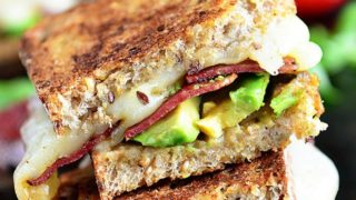 Turkey Bacon and Avocado Grilled Cheese sandwich loaded with fresh basil, tomatoes and mozzarella cheese on a hearty artisan bread.
