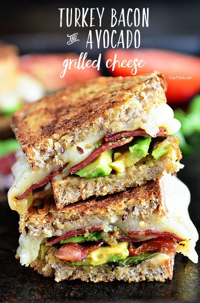 Turkey Bacon and Avocado Grilled Cheese sandwich loaded with fresh basil, tomatoes and mozzarella cheese on a hearty artisan bread. Recipe at TidyMom.net