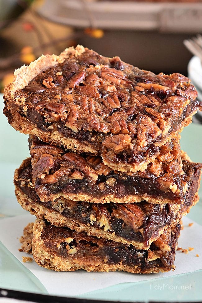 Gooey chocolate pecan pie bars on a plate