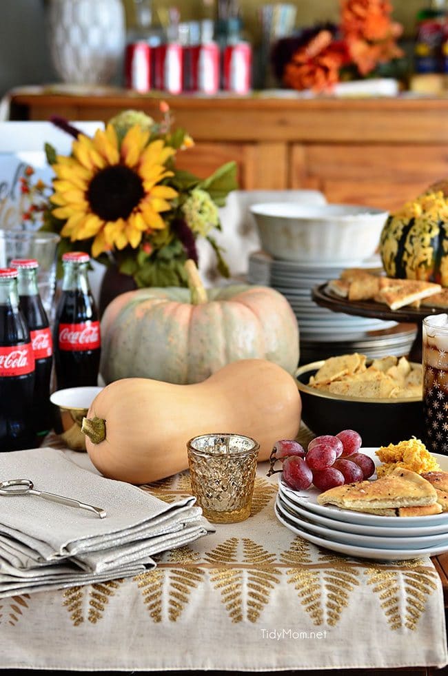 holiday table with gourds and appetizers