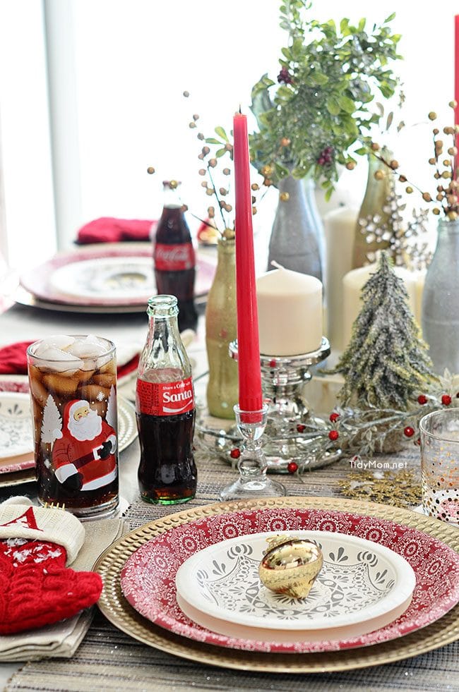 Use empty Cocoa Cola bottles as a pretty holiday table centerpiece. Just paint with glitter spray paint and add some holiday florals, and arrange on a tray. Easy and costs almost nothing! details at TidyMom.net