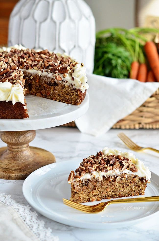 carrot cake on cake stand and cut piece on plate