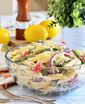 a glass bowl filled with pasta salad